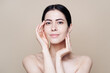 © diignat - Beautiful young Caucasian woman with clean fresh skin on beige background, Face care, Facial treatment, Cosmetology, beauty and spa, brunette women portrait