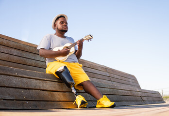 man with prosthetic leg playing musical instrument.