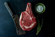 © Stacy Howell - Raw steak with meat cleaver