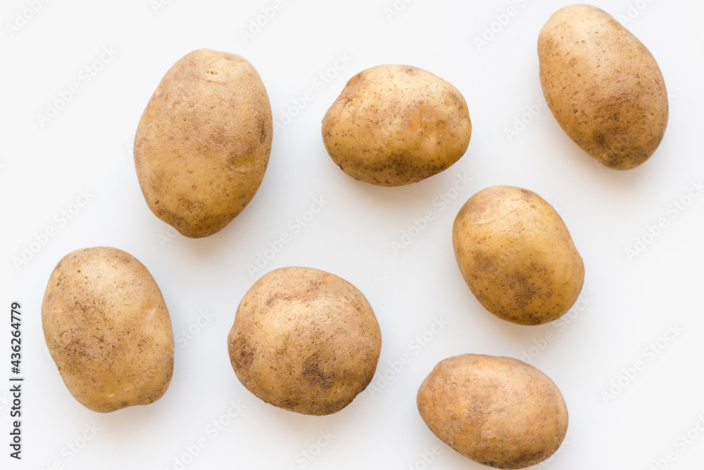 young potatoes on a white plate, potatoes on a white plate  - obrazy, fototapety, plakaty 