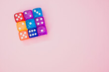 Cube Made Of Colorful Dice Isolated On A Pink Background