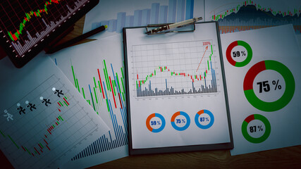 Preparing report. Green and red graphs and charts. Business reports and pile of documents on ash wood top table background.