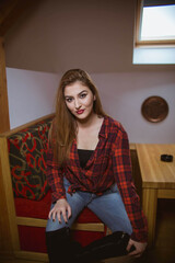 Poster - Vertical shot of a white Caucasian woman wearing a red striped shirt and posing for a picture