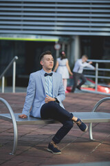 Wall Mural - Young elegant Caucasian man wearing an expensive blue suit at an event