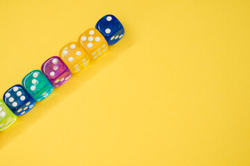 Wall Mural - Dice in a row isolated on a yellow background