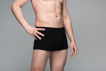 Cropped View Of Shirtless Man In Black Underwear Posing Isolated On Grey.