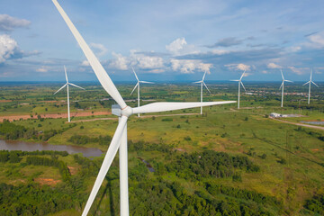 Aerial view of wind turbines or windmills farm field in industry factory. Power, sustainable green clean energy, and environment concept. Nature innovation.