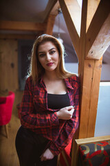 Poster - Vertical shot of a white Caucasian woman posing for a picture on a blurred background