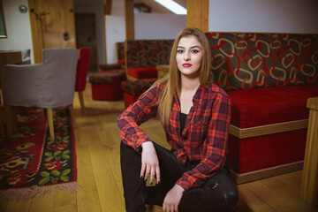 Poster - Vertical shot of a white Caucasian woman posing for a picture in a home studio