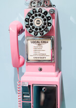 Old Retro Pink Wall Phone On Blue Background