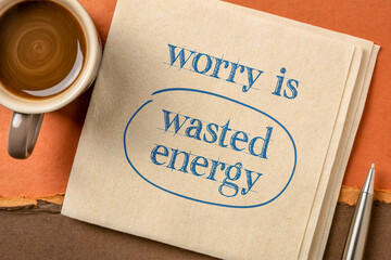 Wall Mural - worry is wasted energy - inspirational handwriting on a napkin with a cup of coffee, positive mindset and optimism concept