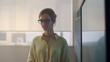 © stockbusters - Teacher standing at blackboard in classroom. Schoolteacher posing in auditorium