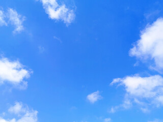 Blue sky with fluffy white clouds.  Beautiful sky in the morning.  Copy space is in the middle of photo.  The concept of new life beginning, freedom of life, positive energy and peaceful mind. 