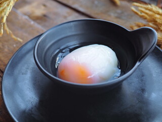 Traditional famous Japanese onsen egg soft boiled, medium rare egg yolk, partly cooked egg white typically served as extra topping in all meals breakfast, lunch, dinner in Japan