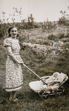 Germany - CIRCA 1930s: Portrait Of Mother And Baby In Carriage. Young Female And Baby In Stroller Pram. Vintage Historical Archive Photo