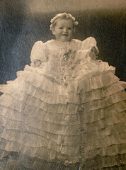 Wall Mural - Germany- CIRCA 1930s: Portrait of baby girl wearing baptism dress in studio. Vintage archive Art Deco era photography