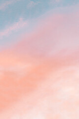 vertical background formed by a bright pastel authentic sky during sunset. pink, peach, blue blur el