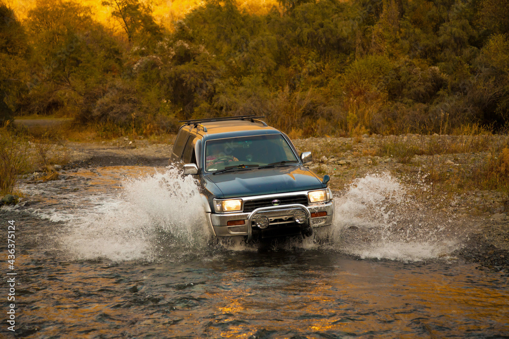 the car passes the river. large SUV in the water Stock Photo | Adobe Stock
