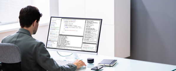 programmer or coder at office desk