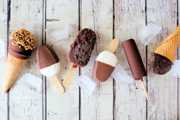 Poster - Assorted chocolate ice cream desserts. Above view scattered on a rustic white wood background.