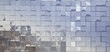The glass mirrored surface of the facade of the modern building in the appearance of square plates sparkling in the sun