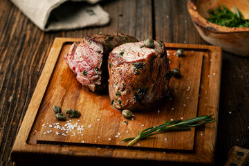 Canvas Print - Grilled meat with spices rosemary and capers on a wooden board