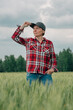 © Bits and Splits - Responsible wheat farmer agronomist looking at her cultivated cereal crop agricultural field
