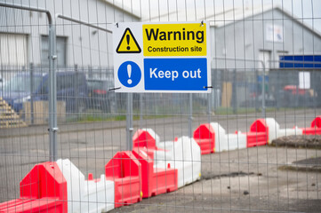 Construction site health and safety message rules sign board signage on fence boundary