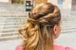 Detail of a half updo hairstyle. Young, blonde woman in a ceremony