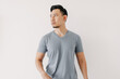 © Sevendeman - Normal portrait of an Asian man in a blue t-shirt isolated on white background.