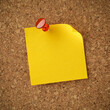 © Leigh Prather - Blank yellow sticky note pinned with red tack. Empty copy space for important office notice, message, or reminder.