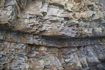 The texture and background of the stones. Rock texture on the sea coast