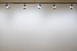 © Luka - Interior with empty white wall with spot lights at art gallery