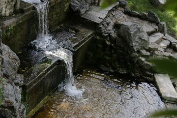 Cascading waterfall in the park. Nature or clear water concept