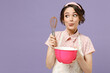 Young thoughtful pensive wistful fun housewife housekeeper chef cook baker woman wear pink apron beating egg yolks whiteslook aside isolated on pastel violet background. Cooking food process concept