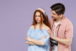 Two frowning indignant traveler tourist woman man couple in casual clothes try to hug apologise isolated on purple background. Passenger travel abroad on weekends getaway. Air flight journey concept