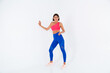 © Анастасия Каргаполов - Fit tanned sporty woman with abs, fitness curves, wearing top and blue leggings on white background