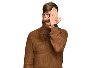 Sticker - Young irish redhead man wearing casual clothes and glasses covering one eye with hand, confident smile on face and surprise emotion.