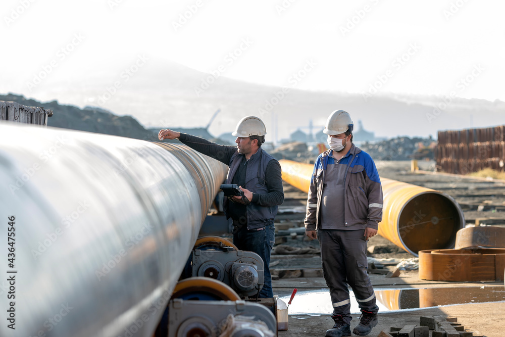Technicians are testing to weld of pipe with ultrasonic test method. It ...