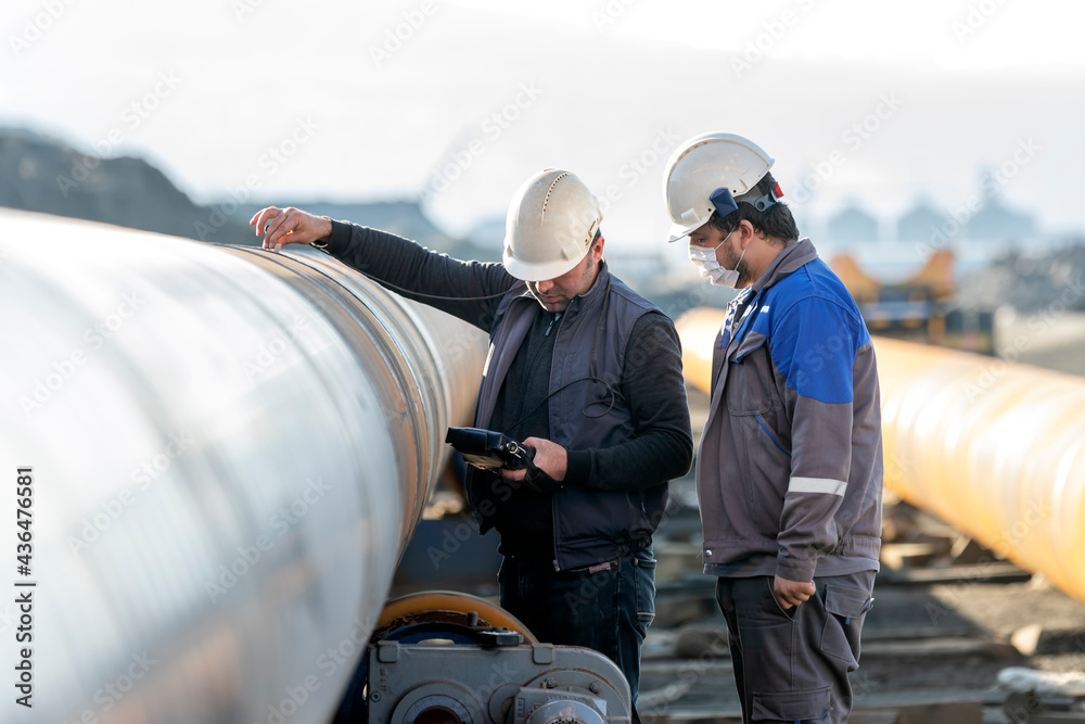 Technicians are testing to weld of pipe with ultrasonic test method. It ...