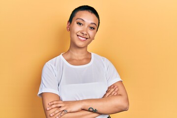 Wall Mural - Beautiful hispanic woman with short hair wearing casual white t shirt happy face smiling with crossed arms looking at the camera. positive person.