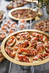 Wall Mural - Delicious bruschetta with salmon and canape shrimp on table. Tasty buffet table. Summer party. Catering concept