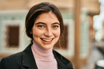 Poster - Young beautiful businesswoman smiling happy standing at the city.