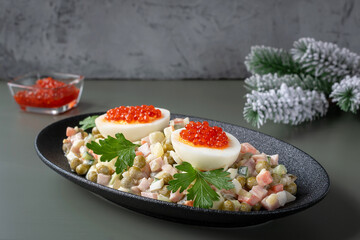 Olivier salad is a traditional Russian dish seasoned with mayonnaise, an essential attribute of the festive New Year's table and Christmas.