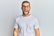 © Krakenimages.com - Young caucasian man wearing casual clothes and glasses sticking tongue out happy with funny expression. emotion concept.