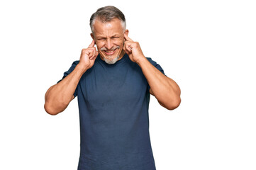 Sticker - Middle age grey-haired man wearing casual clothes covering ears with fingers with annoyed expression for the noise of loud music. deaf concept.