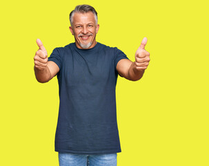 Poster - Middle age grey-haired man wearing casual clothes approving doing positive gesture with hand, thumbs up smiling and happy for success. winner gesture.