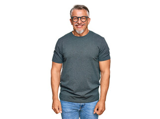 Canvas Print - Middle age grey-haired man wearing casual clothes and glasses looking positive and happy standing and smiling with a confident smile showing teeth