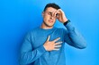 © Krakenimages.com - Hispanic young man wearing casual winter sweater touching forehead for illness and fever, flu and cold, virus sick
