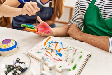 Wall Mural - Couple painting hands at art studio.